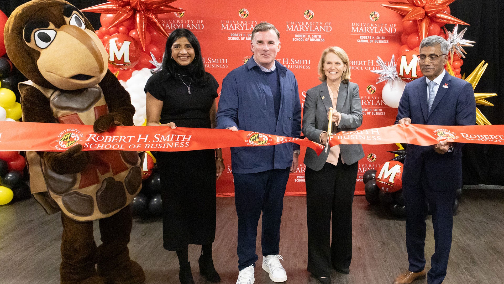Testudo joins Maryland Lt. Gov. Aruna Miller, Under Armour founder and CEO Kevin Plank, UMD Provost Jennifer King Rice and Dean Prabhudev Konana at a ribbon-cutting for the Smith School’s Baltimore campus.