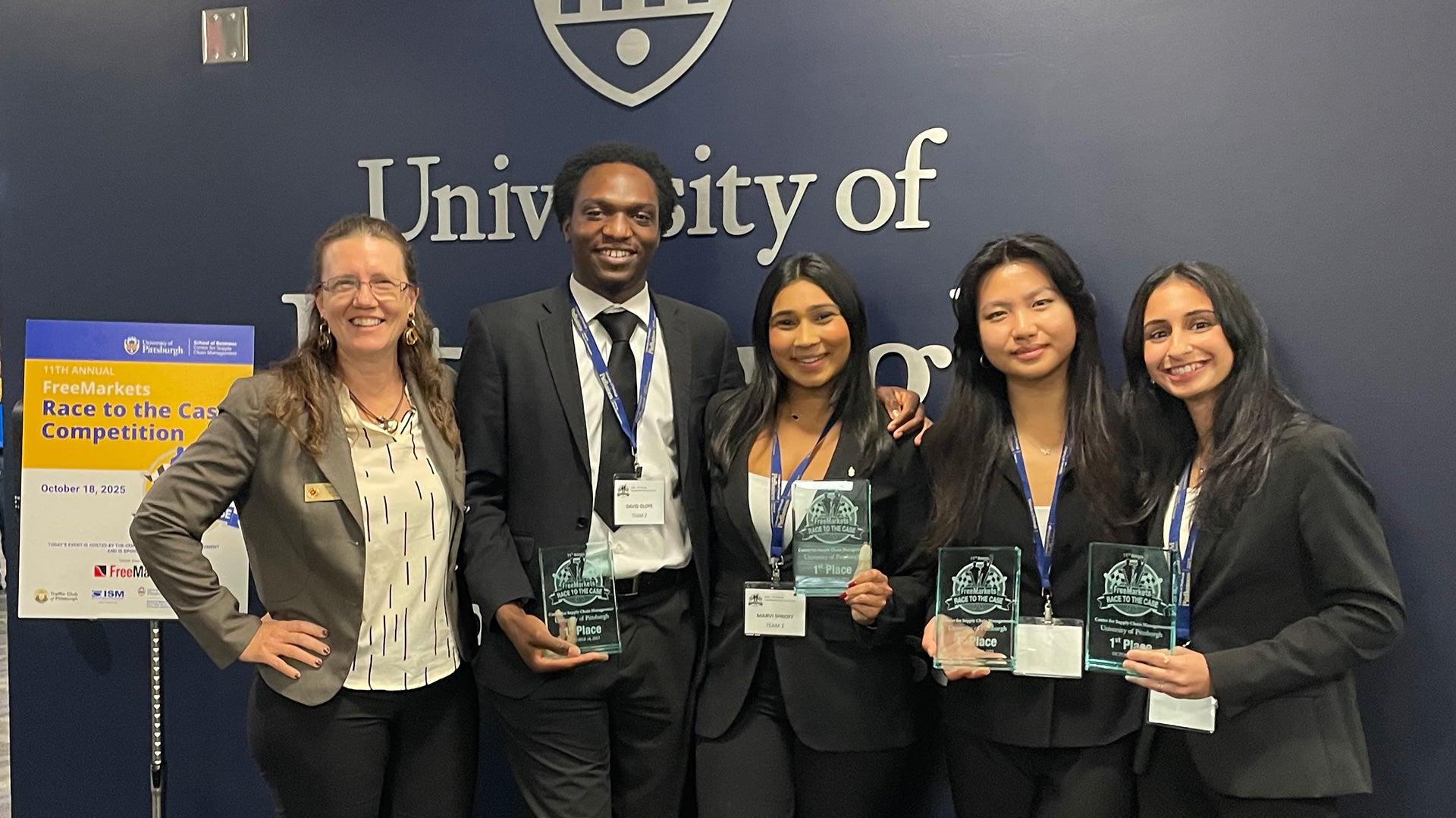 Four University of Maryland QUEST Honors Program students and their advisor pose with first-place awards at the University of Pittsburgh’s FreeMarkets Race to the Case Supply Chain Management Competition on October 18, 2025.