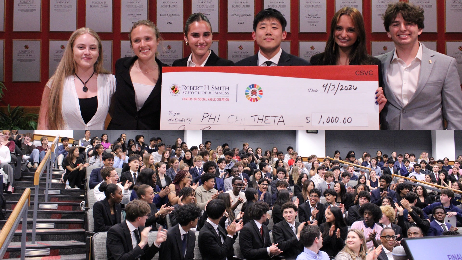 Students hold first-place check while audience applauds at Smith School interfraternity case competition