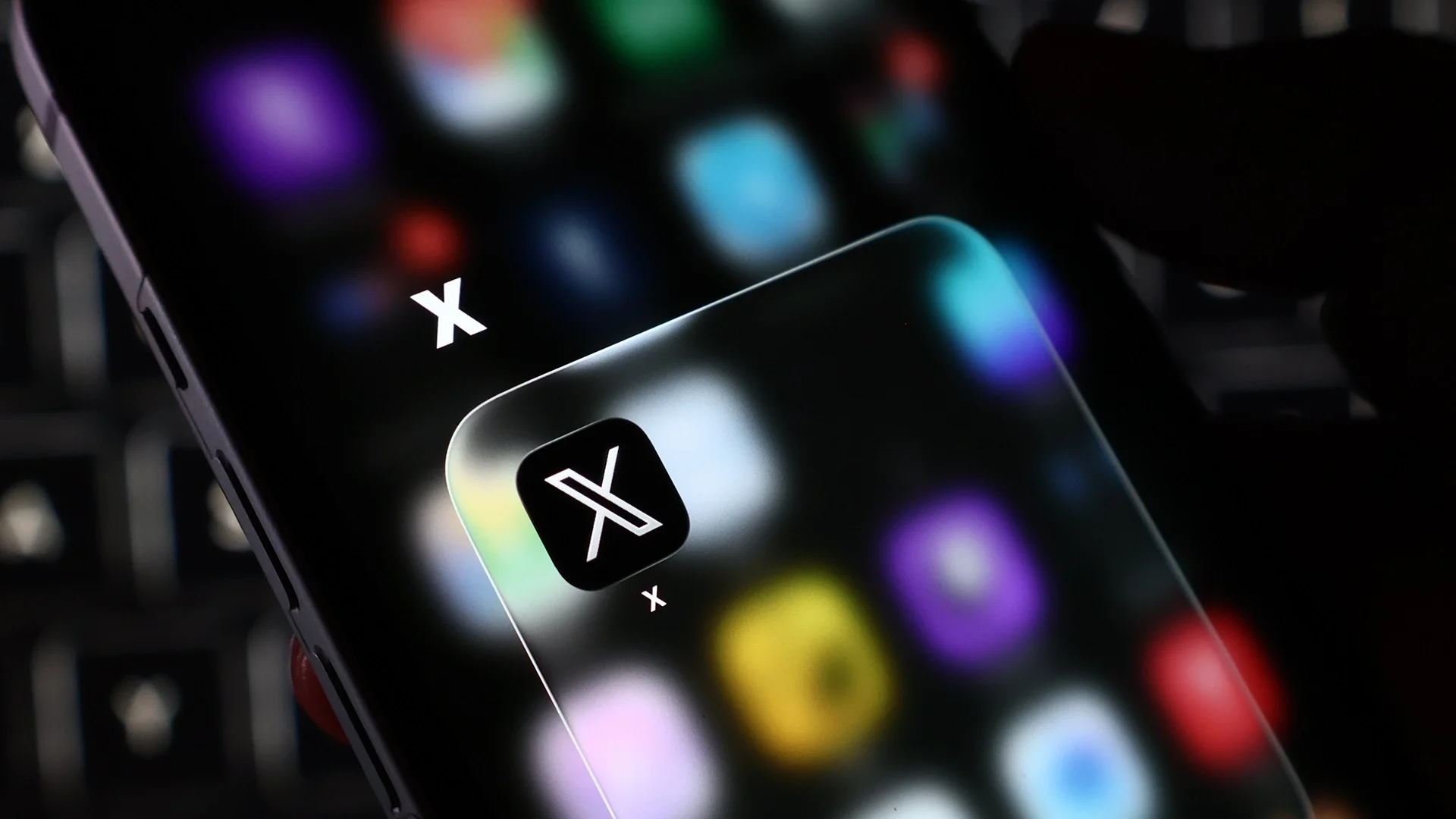 X social media app logo displayed on smartphone screens.