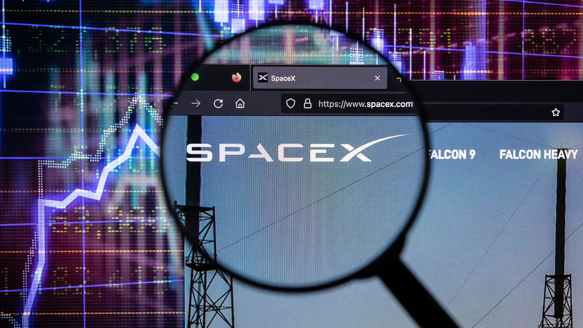 Magnifying glass over the SpaceX website with stock market charts in the background, illustrating investor attention surrounding the company’s record-setting IPO.