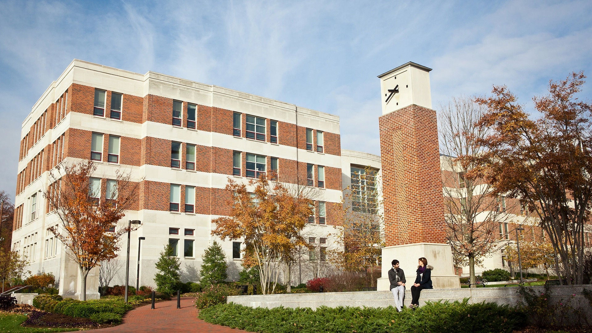 Photo of Van Munching Hall with the clock tower in the foreground.