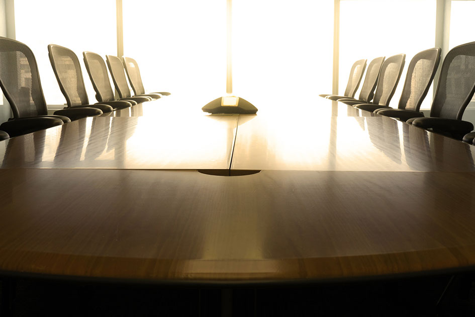 Photo of a conference room table and chairs