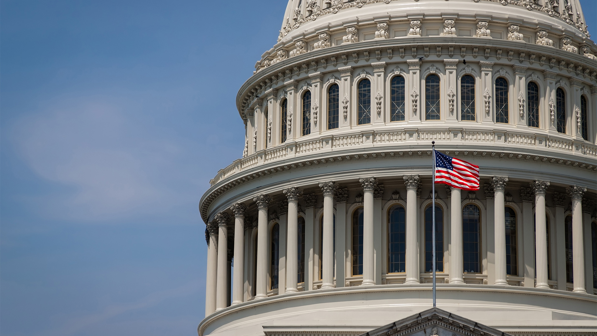 Photo of the US Capitol dome with the flag