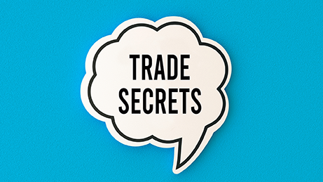 Speech bubble containing the words “Trade Secrets” on a blue background.