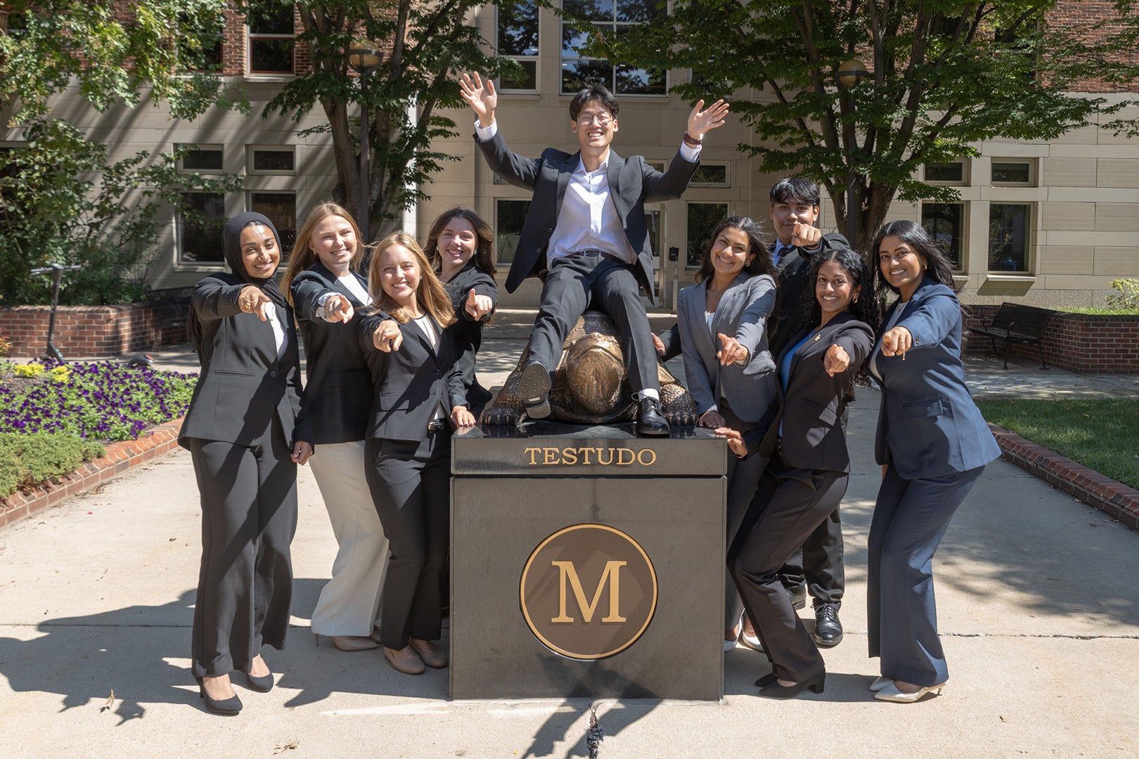 Dean’s Student Advisory Council members pose around the Testudo statue at the Smith School of Business.