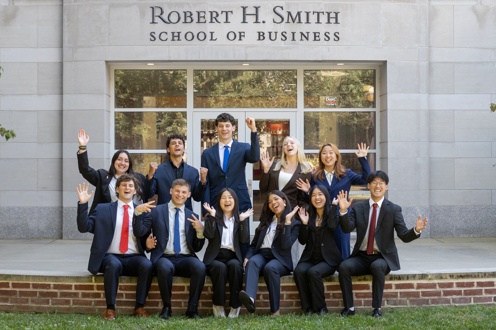 Smith Community Council student leaders cheerfully pose outside the Robert H. Smith School of Business.